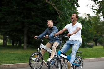 Two,young,cheerful,male,friends,having,fun,together,in,green