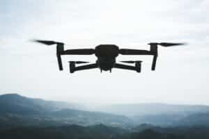 Folding,small,drone,is,flying,over,the,mountains
