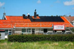 Three Men Installing Solar Panels On A House